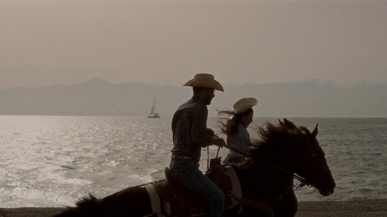 Bride and groom on horseback by the sea in Calabria - a frame from a wedding film