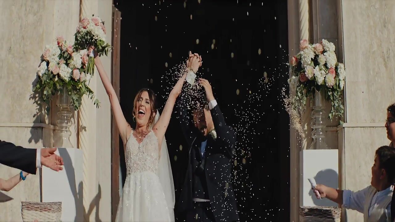 The newlyweds exiting under a shower of rice - a spontaneous moment captured by Giuseppe Cimino