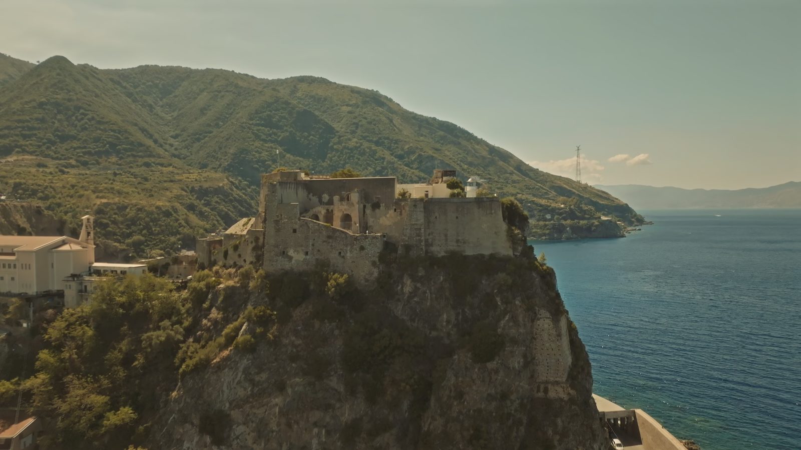 The Ruffo castle of Scilla seen from above, with the Strait of Messina beyond